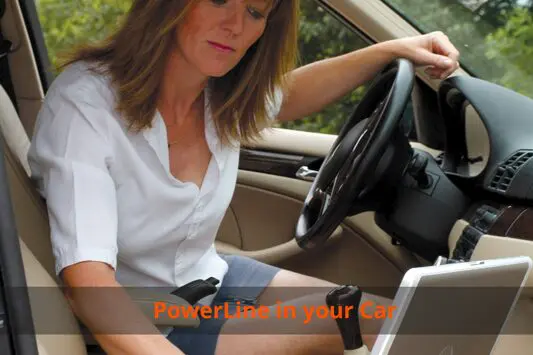 A woman sitting in the drivers seat of her car looking at her laptop.