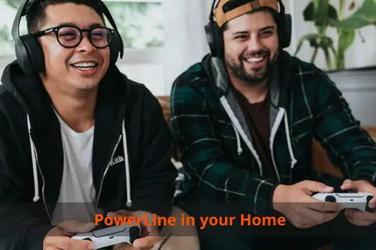 Two men sitting on a couch with headphones on.